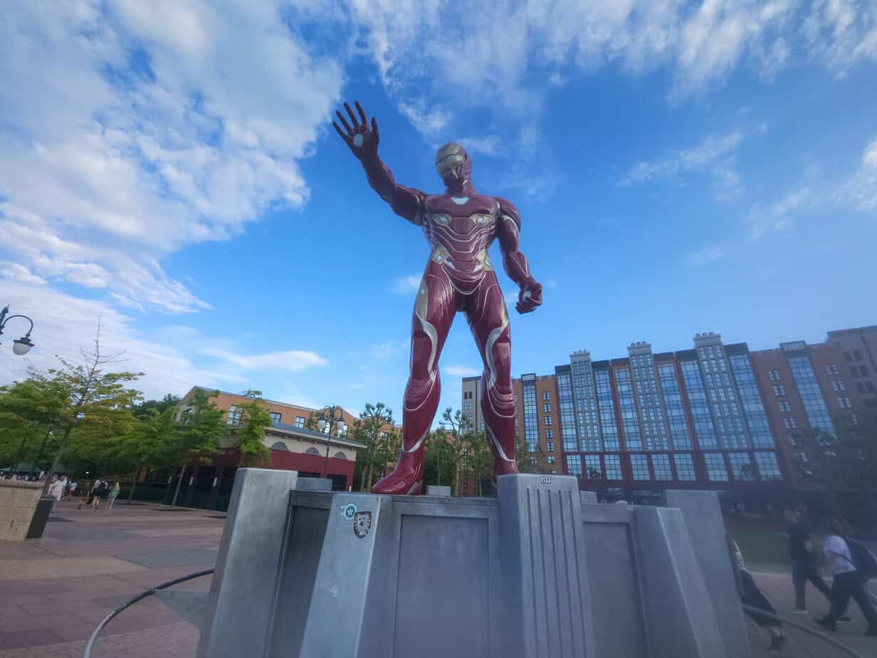 Large Iron Man statue on a pedestal outside Disney Hotel New York – The Art of Marvel, which is among the best disneyland paris hotels with pools for superhero fans.
