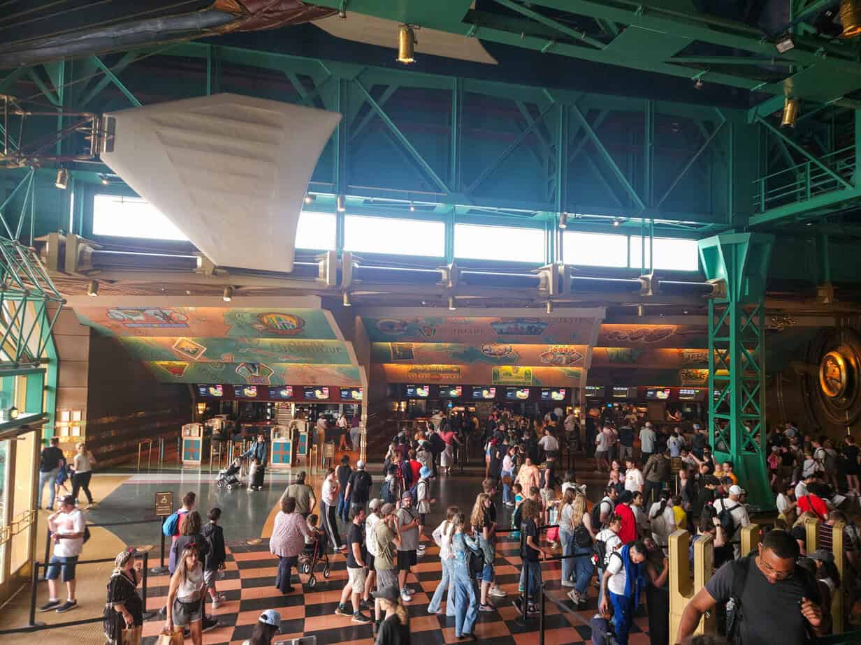 Busy food court at Café Hyperion in Disneyland Paris with long queues during peak time.
