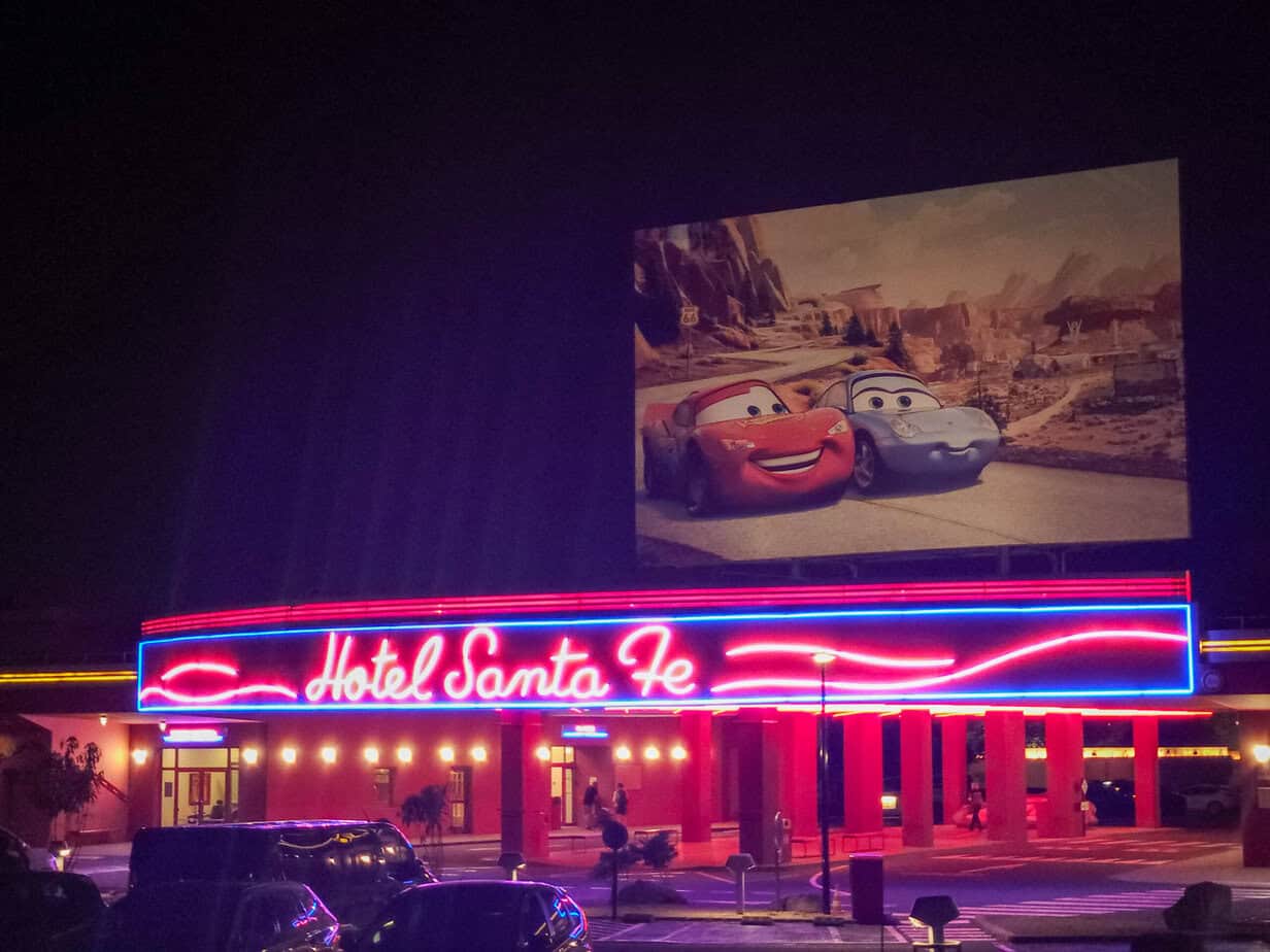 Hotel Santa Fe at Disneyland Paris lit up at night with Cars-themed décor.