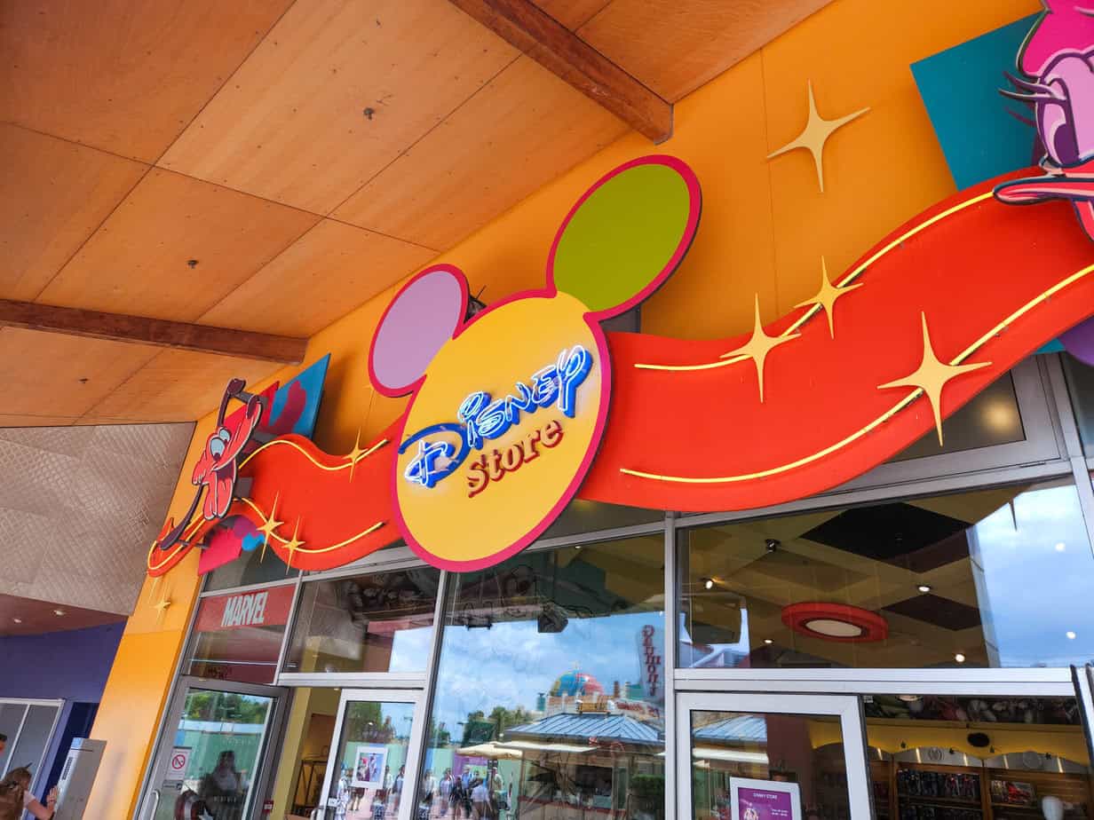 Colourful entrance to the Disney Store in Disney Village, with a bright sign and Marvel section visible inside.