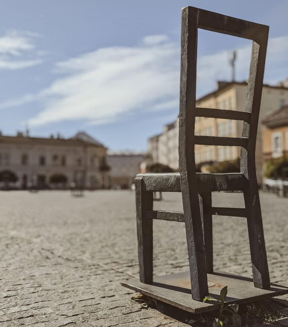 Close-up of a single metal chair from the Ghetto Heroes Square memorial in Krakow’s Podgórze district, commemorating Holocaust victims.